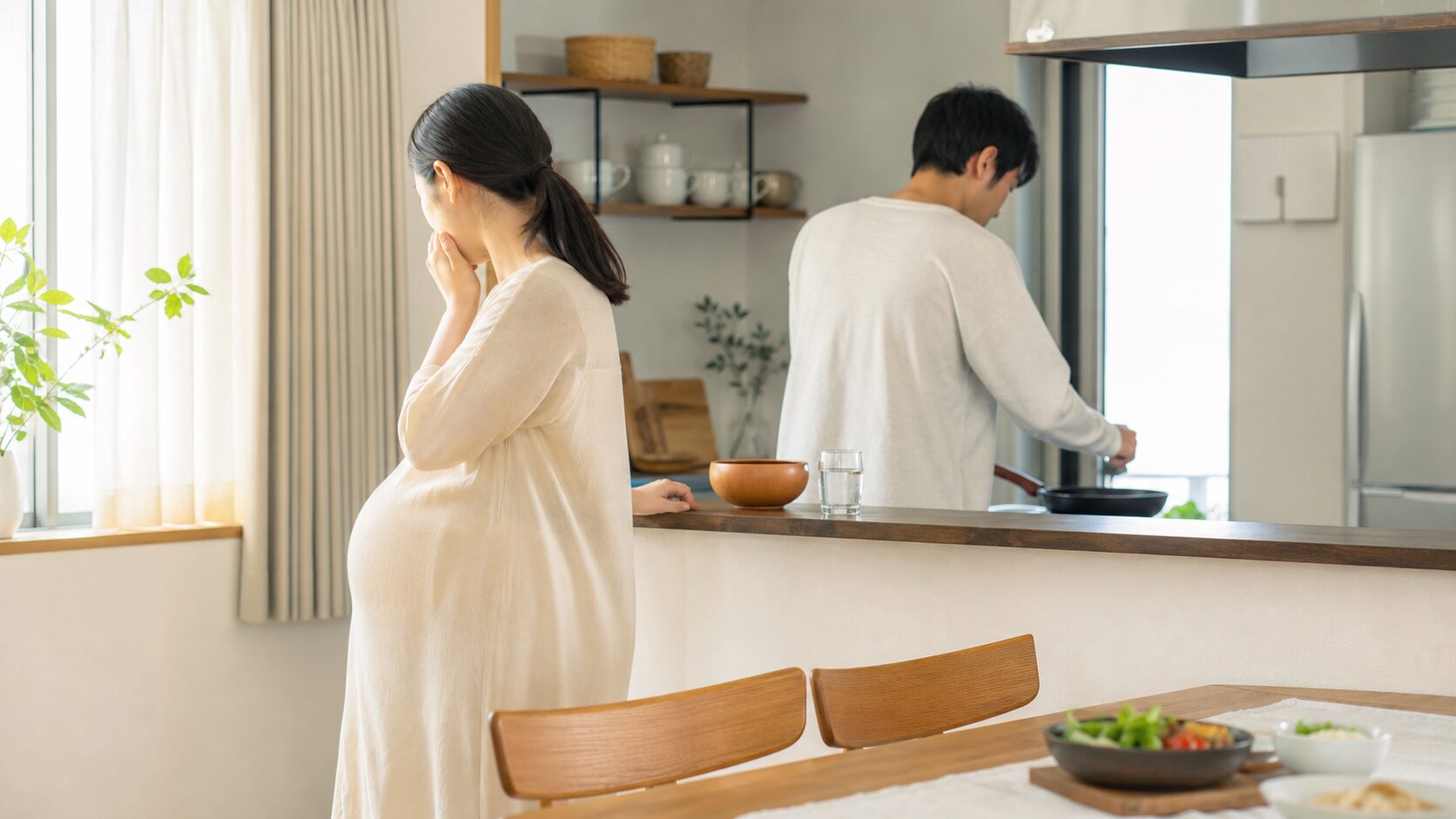 妊娠初期のにおいづわりでキッチンから少し離れて休む家庭のイメージ