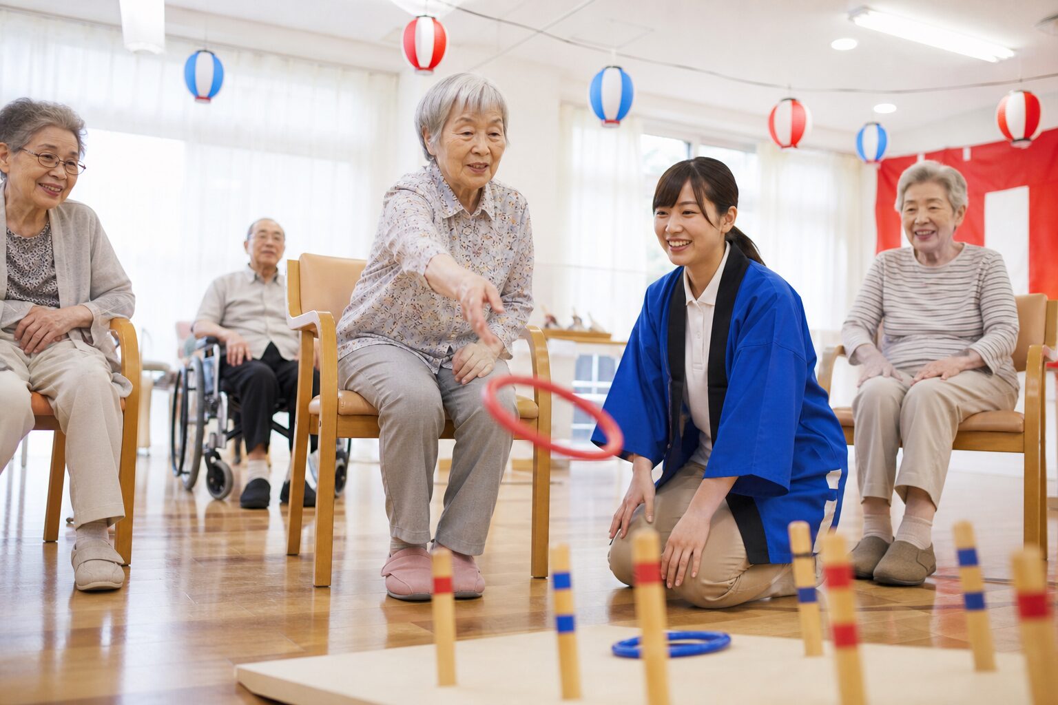 椅子に座ったまま輪投げを楽しむ高齢者向けレクリエーションのイメージ