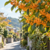 秋の日差しの中、住宅街の道沿いに咲くオレンジ色の金木犀